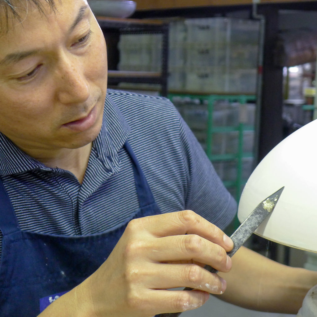Checking for flaws in Arita Porcelain, Japan