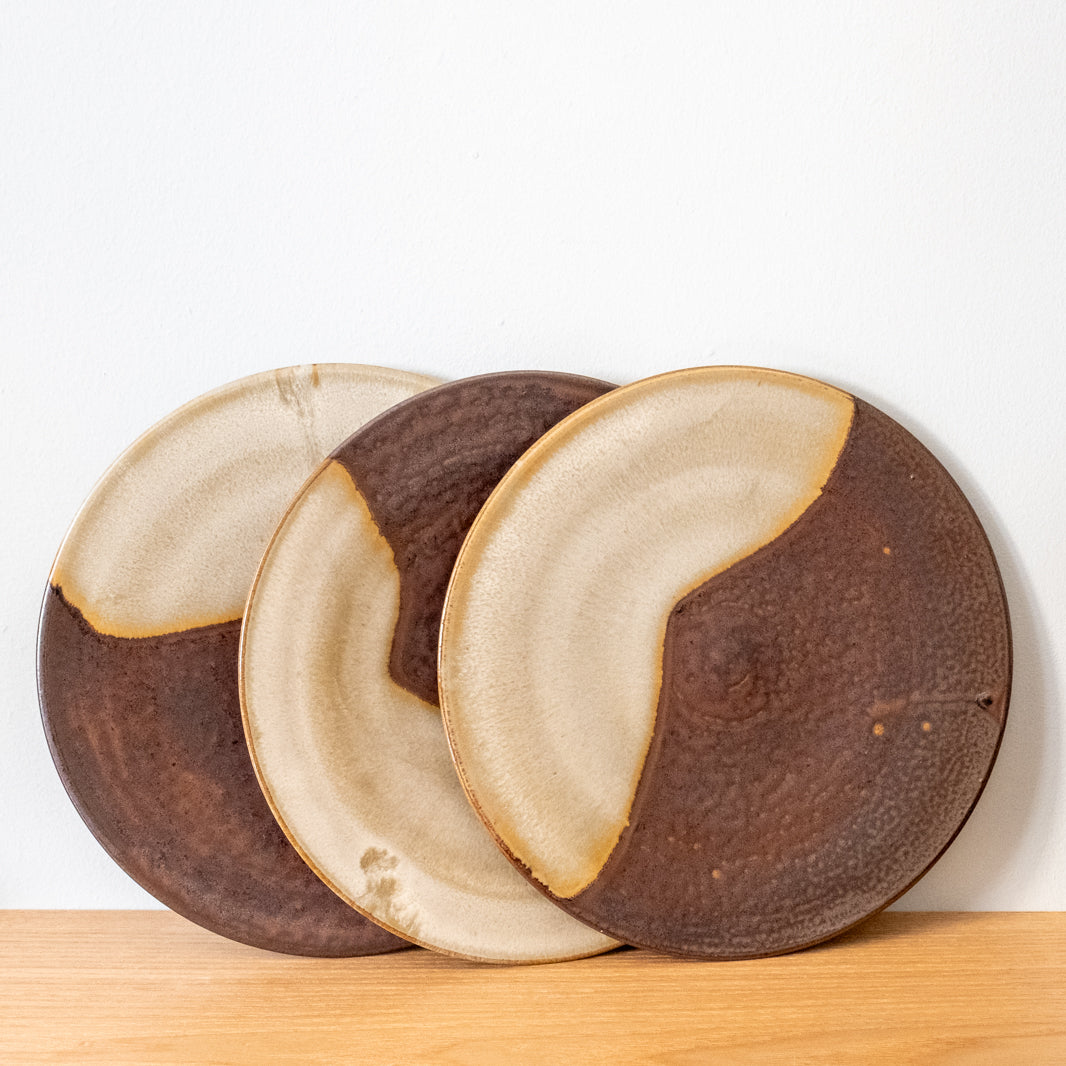 Finely made, flat stoneware plates, brown with yellow glaze, handmade in Japan