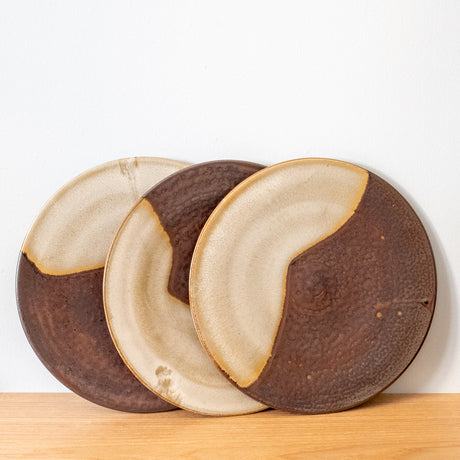 Finely made, flat stoneware plates, brown with yellow glaze, handmade in Japan