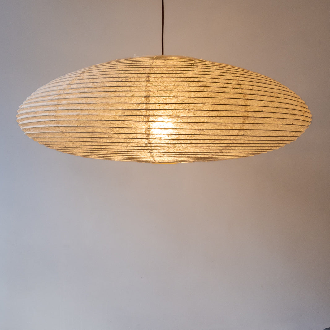 90cm diameter, large oval paper lampshade, handmade in Japan from Hemp (Asaraku) paper, which has large random holes in it - straight view, illuminated