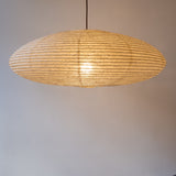 90cm diameter, large oval paper lampshade, handmade in Japan from Hemp (Asaraku) paper, which has large random holes in it - straight view, illuminated