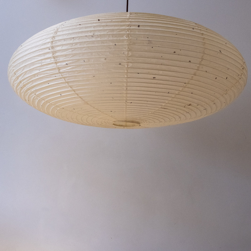 An elliptical 90cm Japanese paper lampshade, made from warm organic natural kozo washi paper, underneath view