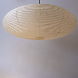 An elliptical 90cm Japanese paper lampshade, made from warm organic natural kozo washi paper, underneath view