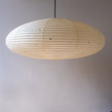 An elliptical 90cm Japanese paper lampshade, made from warm organic natural kozo washi paper