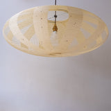 A 90cm diameter elliptical, kozo Japanese paper lampshade in the skashi style (constructed in strips), unilluminated.