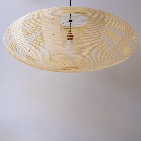 A 90cm diameter elliptical, kozo Japanese paper lampshade in the skashi style (constructed in strips), unilluminated.