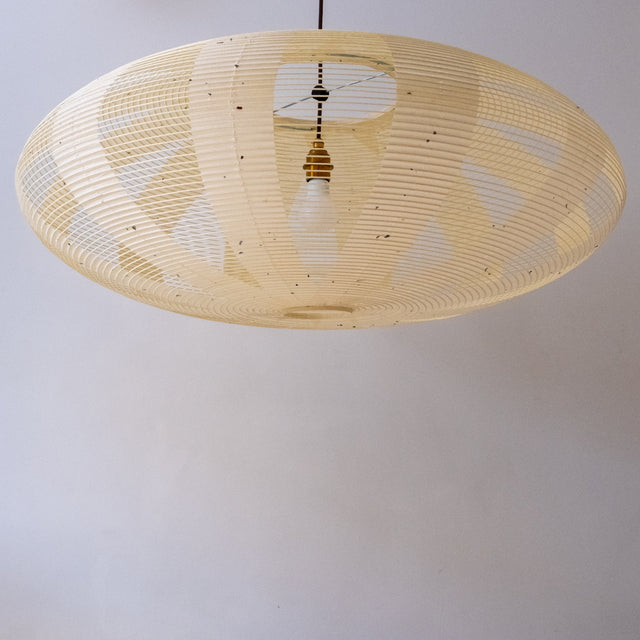 A 90cm diameter elliptical, kozo Japanese paper lampshade in the skashi style (constructed in strips), unilluminated.