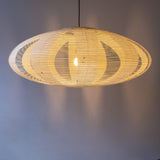 A 90cm diameter oval, kozo washi Japanese paper lampshade in the skashi style (constructed in strips), side view, illuminated.