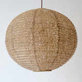A 53cm diameter khaki coloured hemp paper lampshade in the asaraku style, with small holes left in the paper.