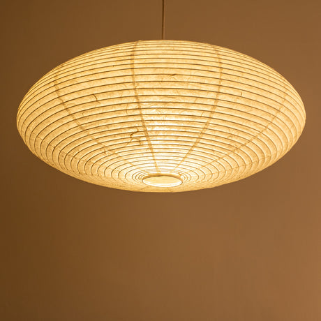 An elliptical-shaped Japanese paper lampshade from white Unryu paper, pictured from beneath, lit.