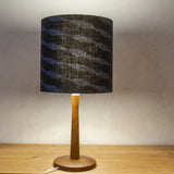 A black cotton shade with winding blue decoration